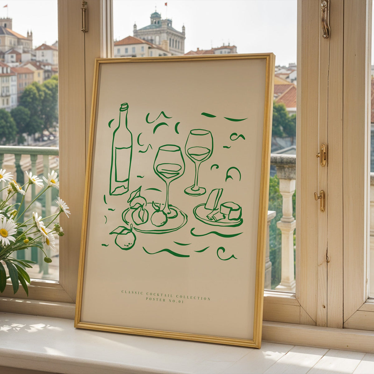 Green line wine and cheese print in a gold frame on a window sill above a hillside town