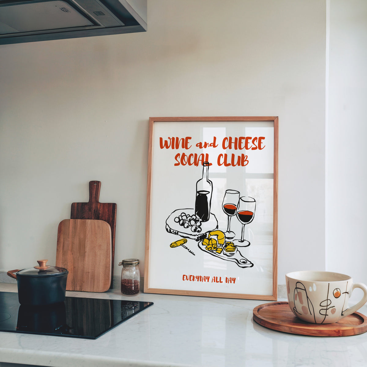 Wine and Cheese Social Club print in a pine frame on a marble counter