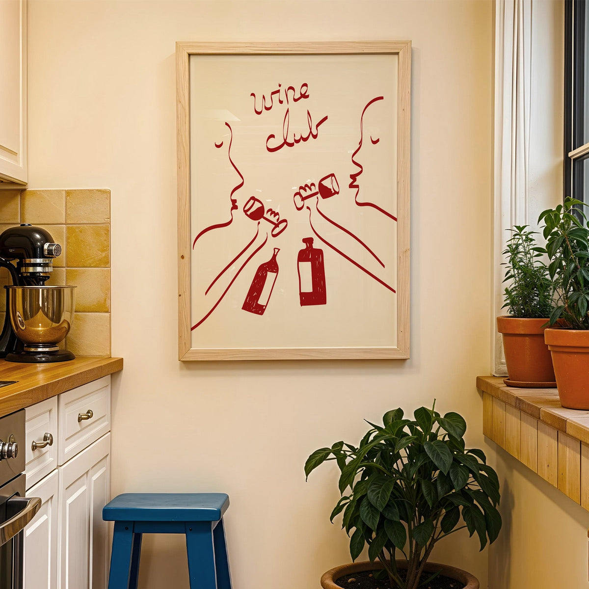 Wine club faces line art print in a wood frame on a yellow tiled kitchen wall