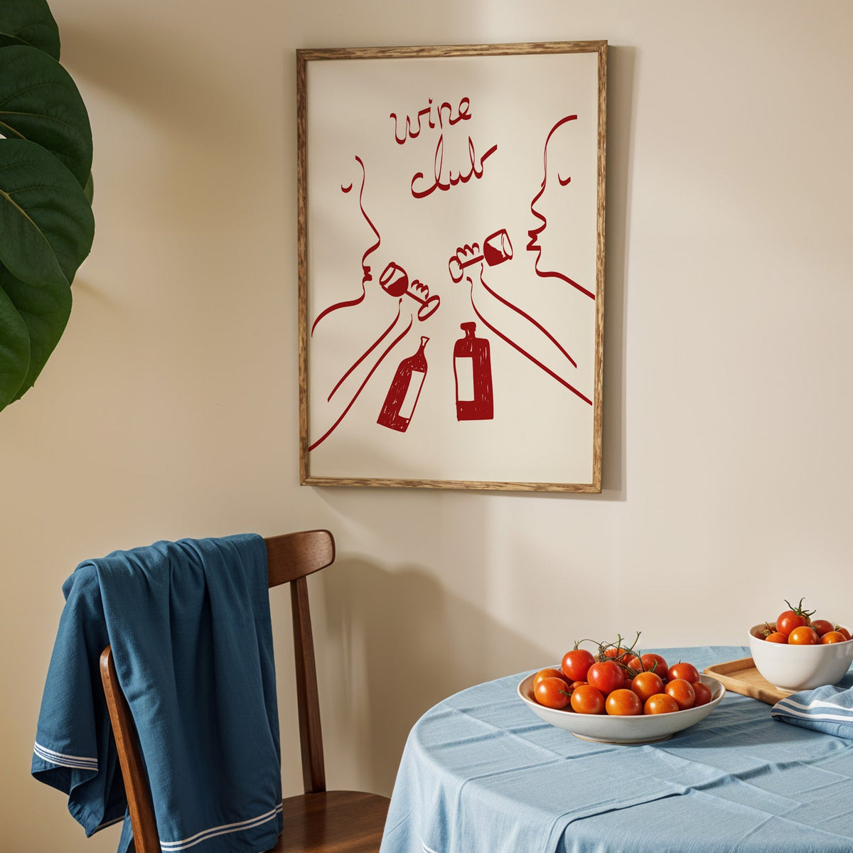 Wine club faces line art print in an oak frame above a blue linen table
