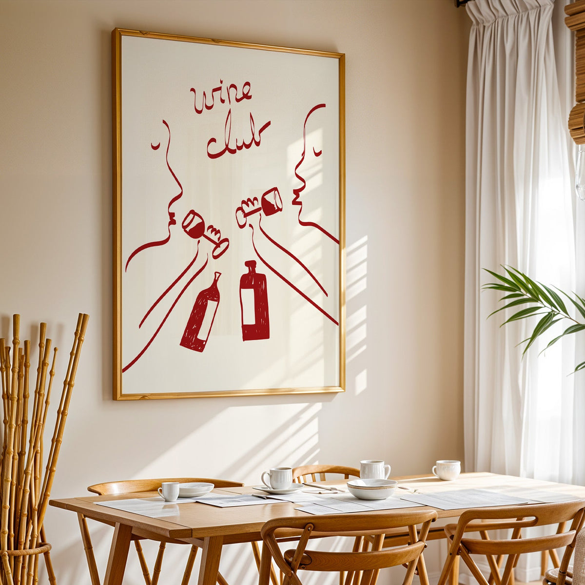 Wine club faces line art print in a gold frame above a sunlit breakfast table