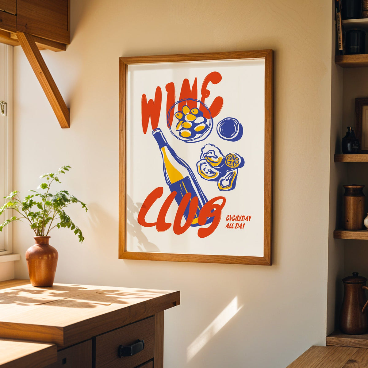 Wine Club oysters print in a walnut frame on a cream kitchen wall above the island