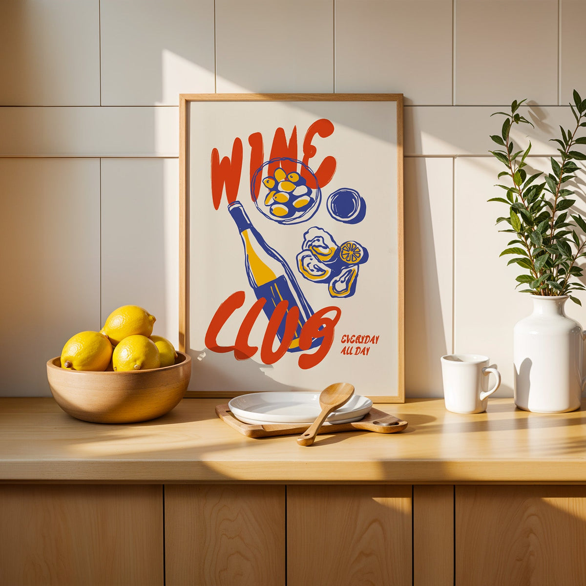Wine Club oysters print in a slim oak frame beside a wooden bowl of lemons