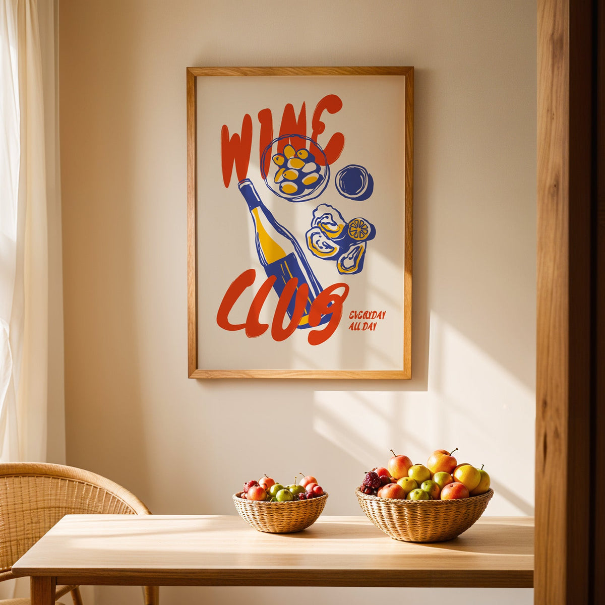 Wine Club oysters print in an oak frame hanging above a dining table with rattan chairs