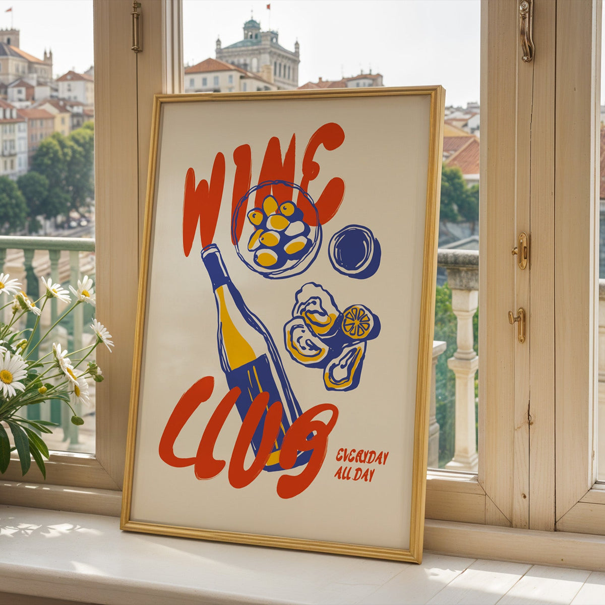 Wine Club oysters print in a gold frame on a window sill above a European hillside town