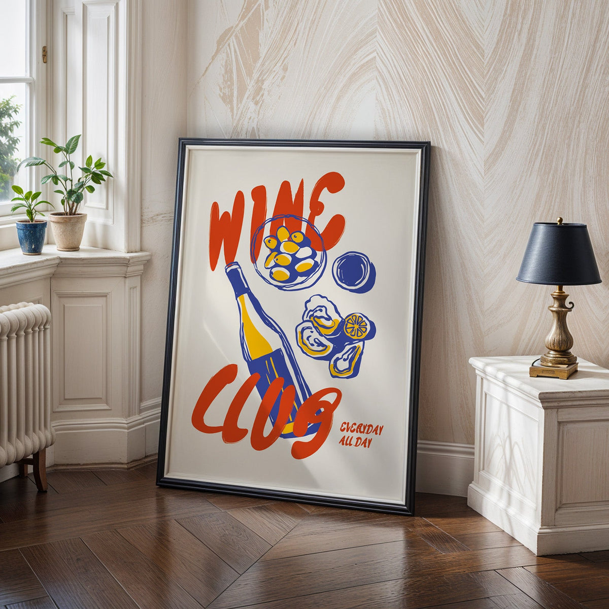 Wine Club oysters print in a black frame on a dark herringbone floor by a radiator