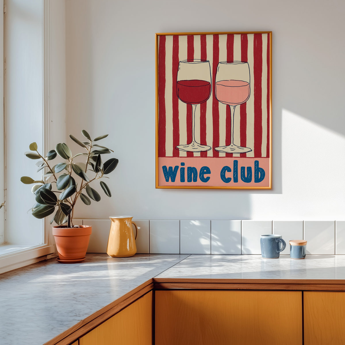 Wine Club print shown in a gold frame above a marble counter in a tan kitchen