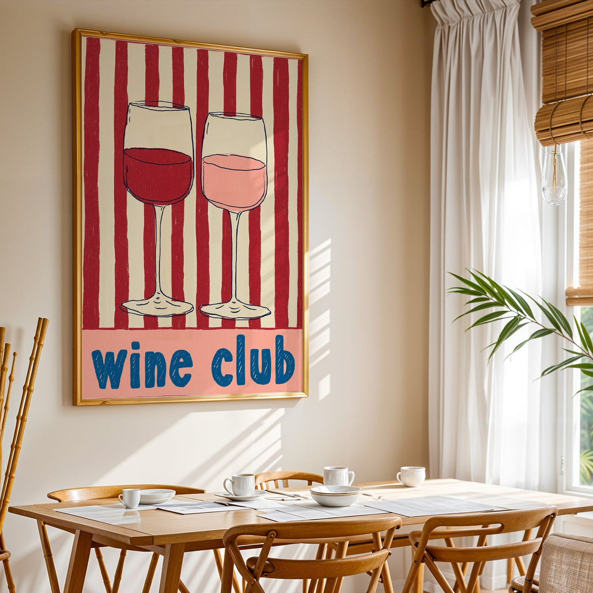 Wine Club print shown in a gold frame above a breakfast table by a curtained window