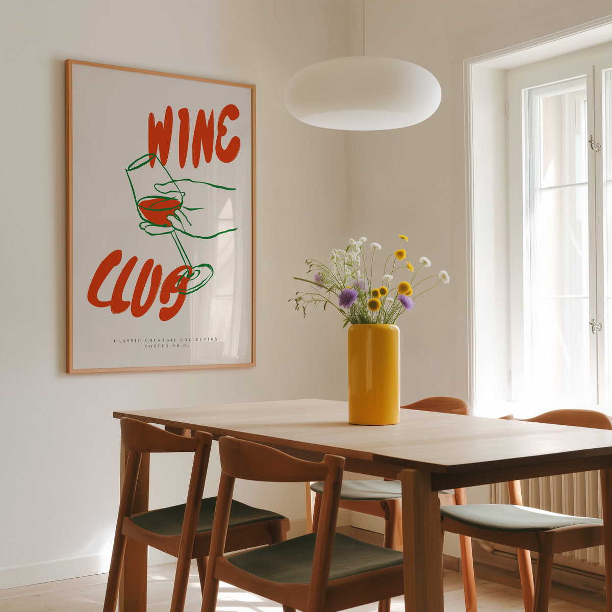 Wine Club tilted glass print in a slim oak frame above a dining table
