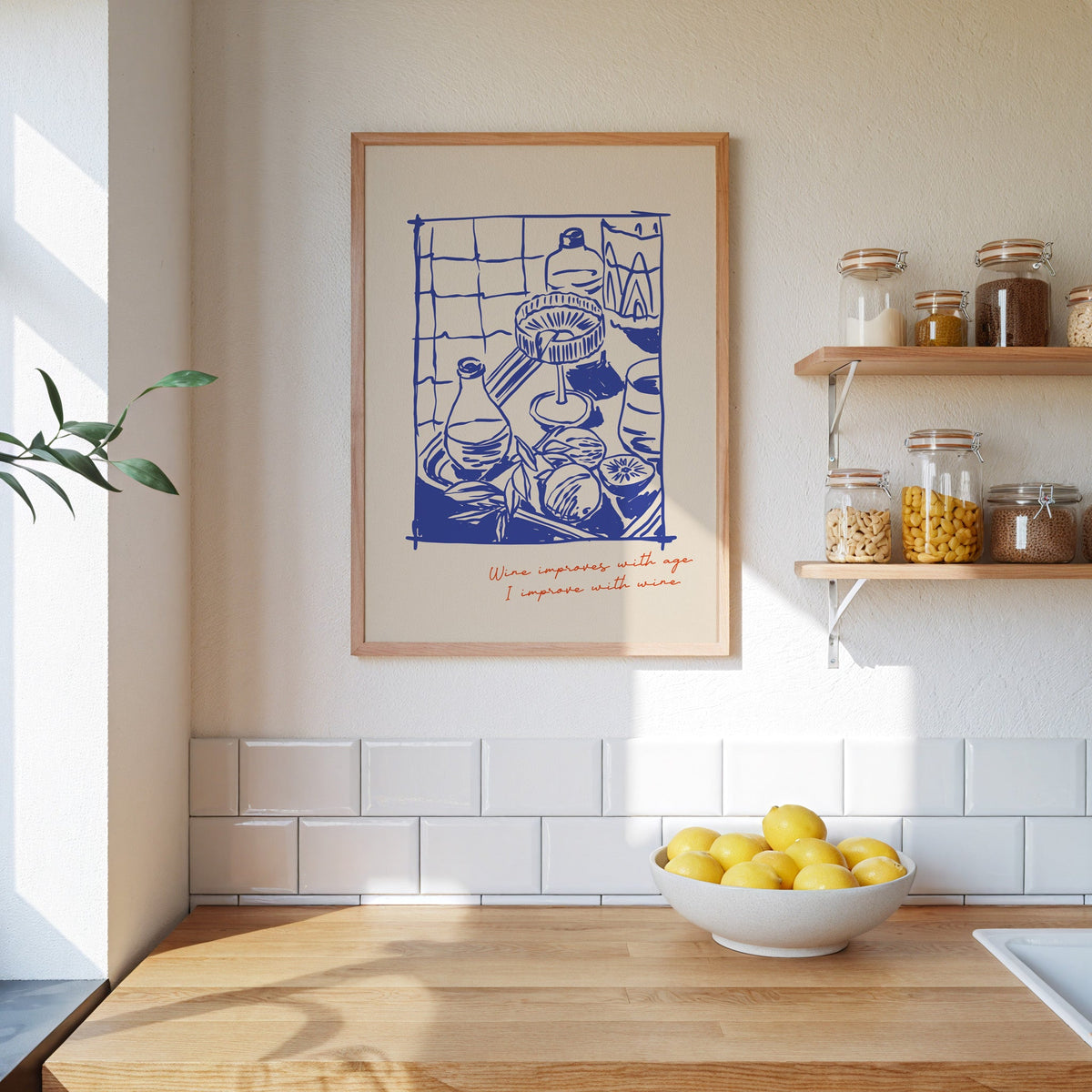 Wine Improves With Age shelf print in an oak frame beside open kitchen shelves