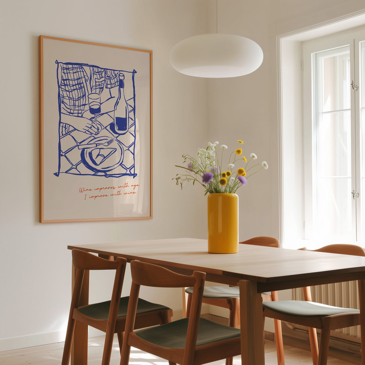 Wine Improves With Age print in a slim oak frame above a dining table