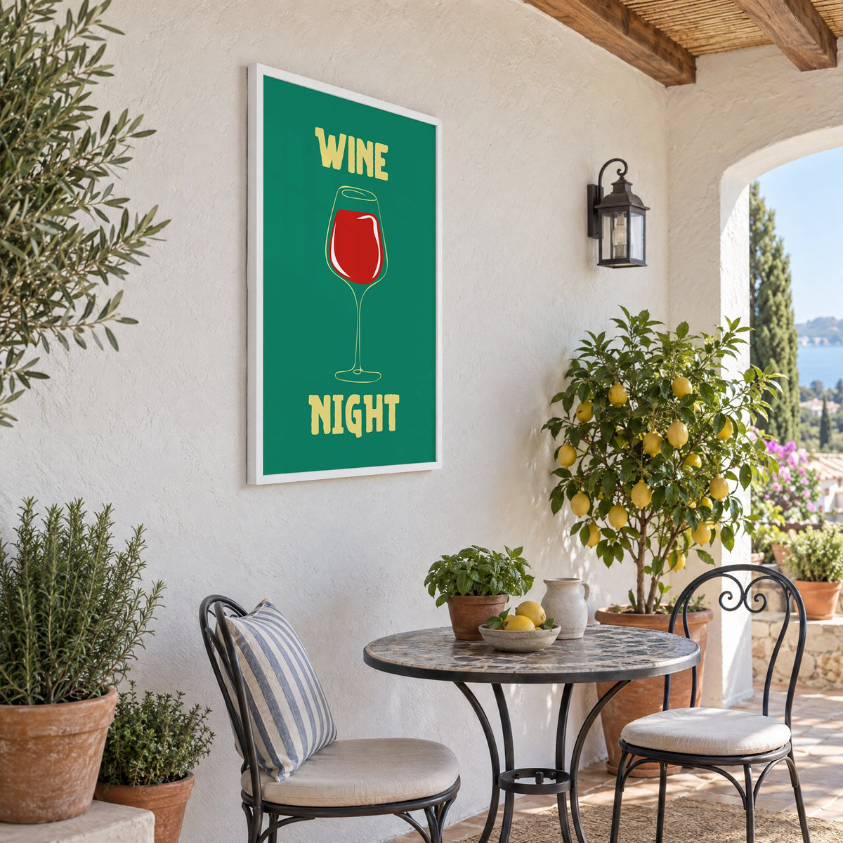 Wine Night red glass print in a white frame on a sunny patio wall beside a potted lemon tree