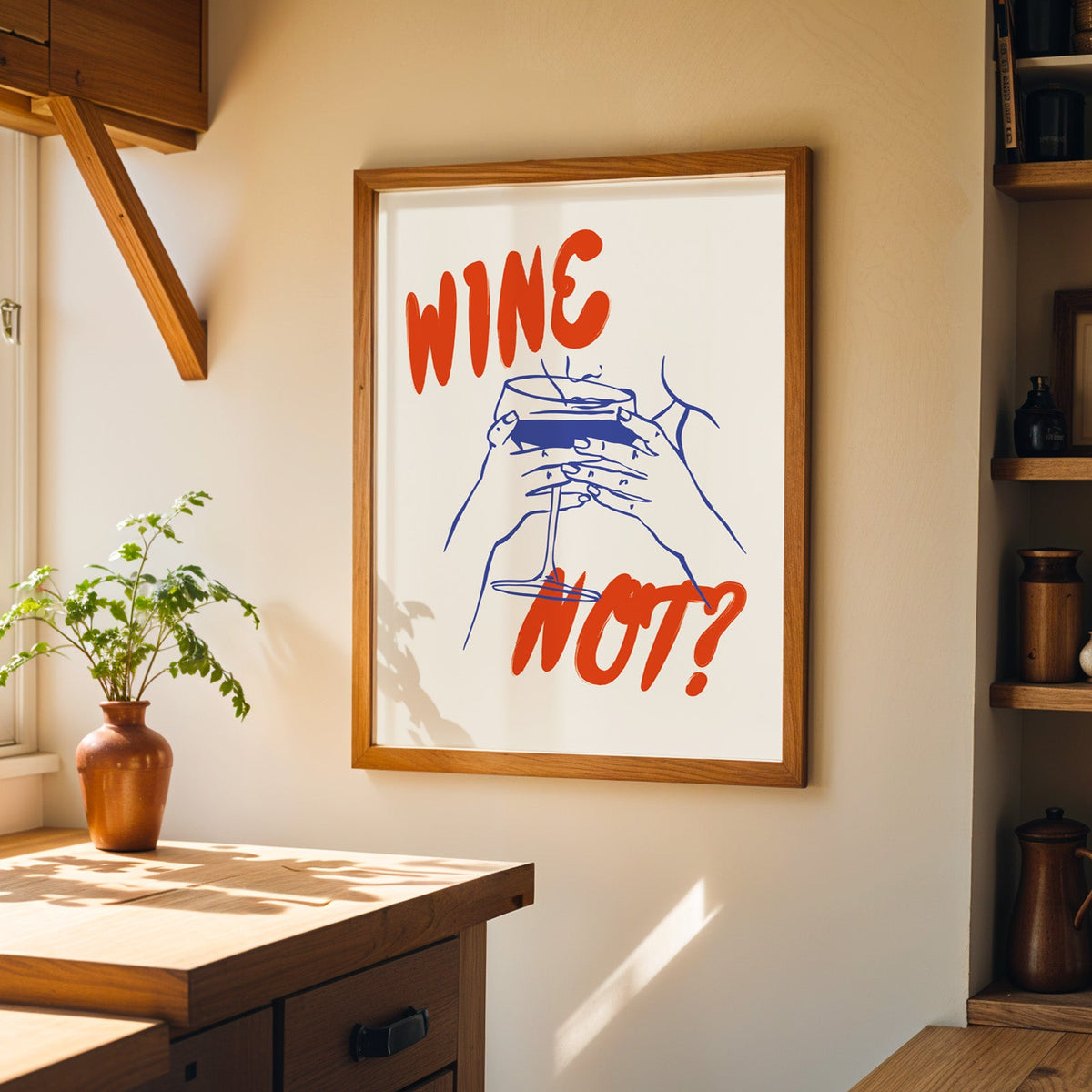 Wine Not print in a walnut frame on a cream kitchen wall above the island