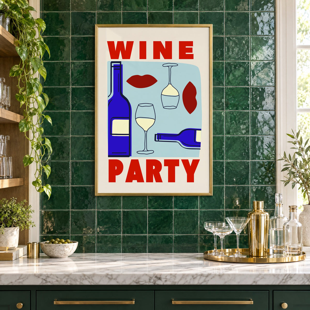 Wine Party bottles and red lips print in a brass frame on emerald green tiles above a home bar with coupe glasses