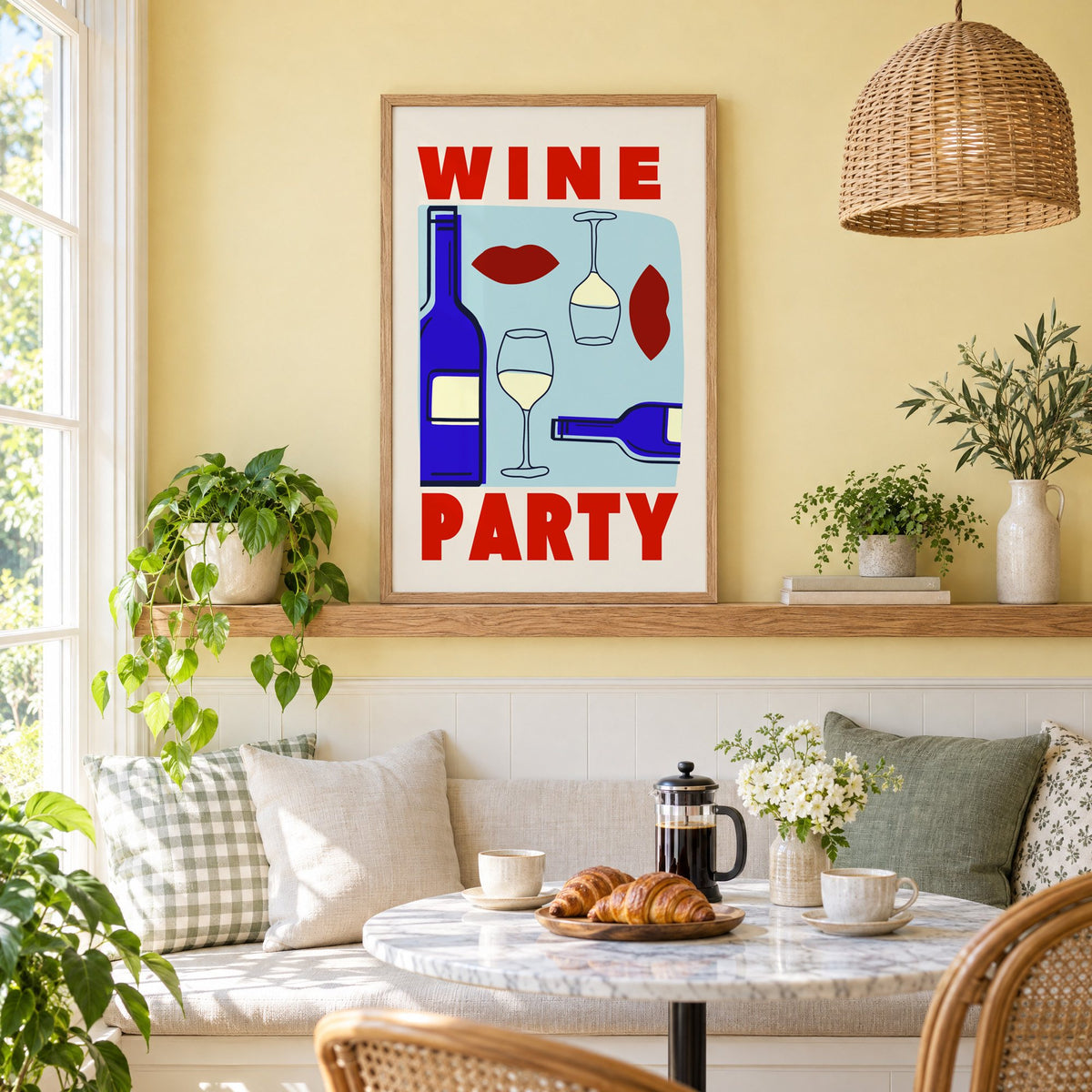 Wine Party bottles and red lips print in an oak frame on a picture ledge above a sunny breakfast nook
