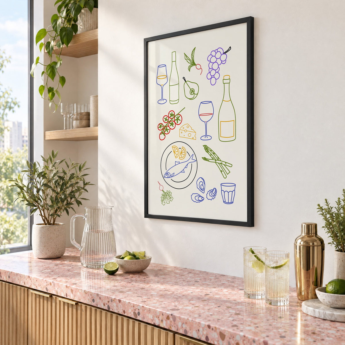 Colorful wine picnic line art print in a black frame above a pink terrazzo cocktail counter with limes, seen at an angle