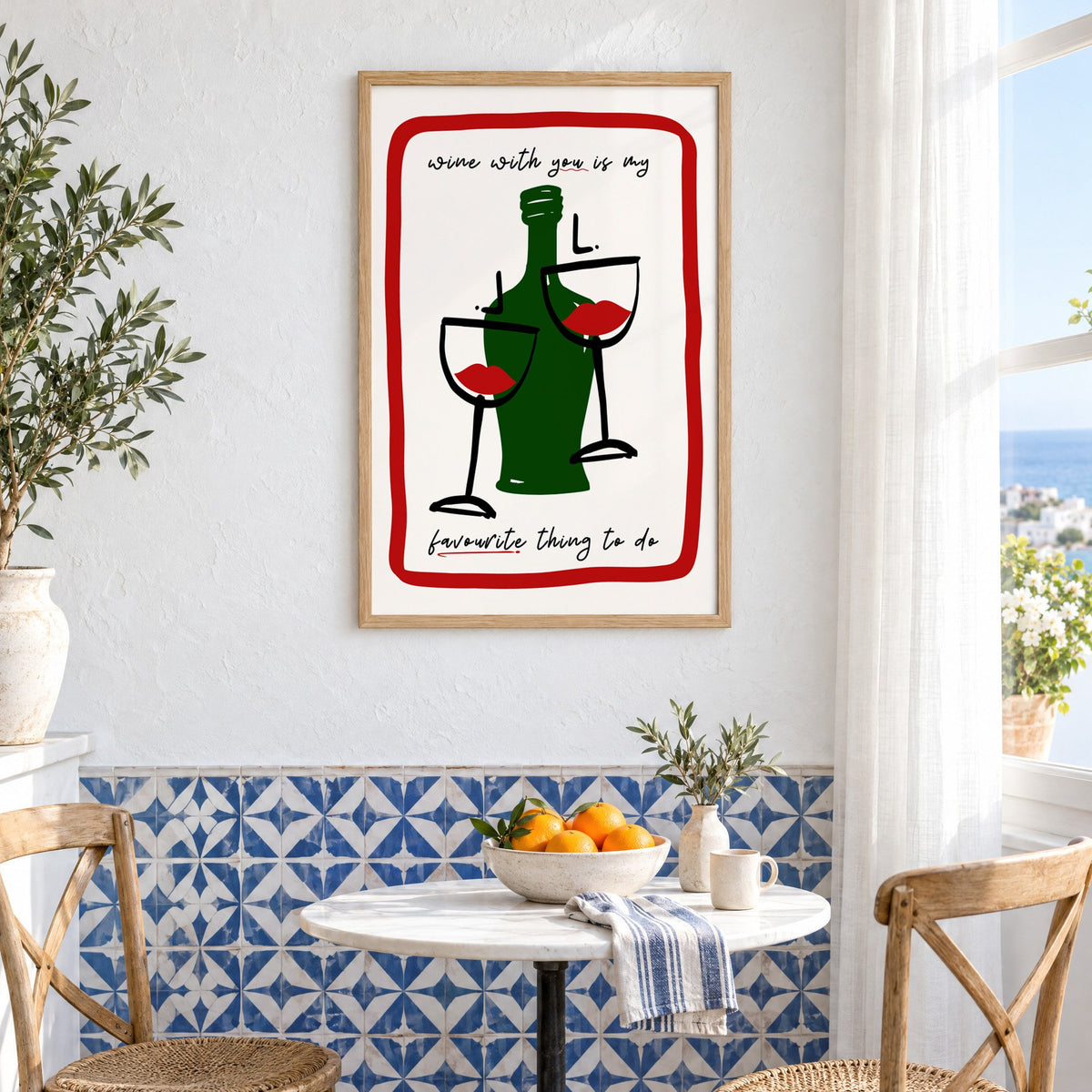 Wine with you lip glasses print in an oak frame above a bistro table and blue patterned tiles