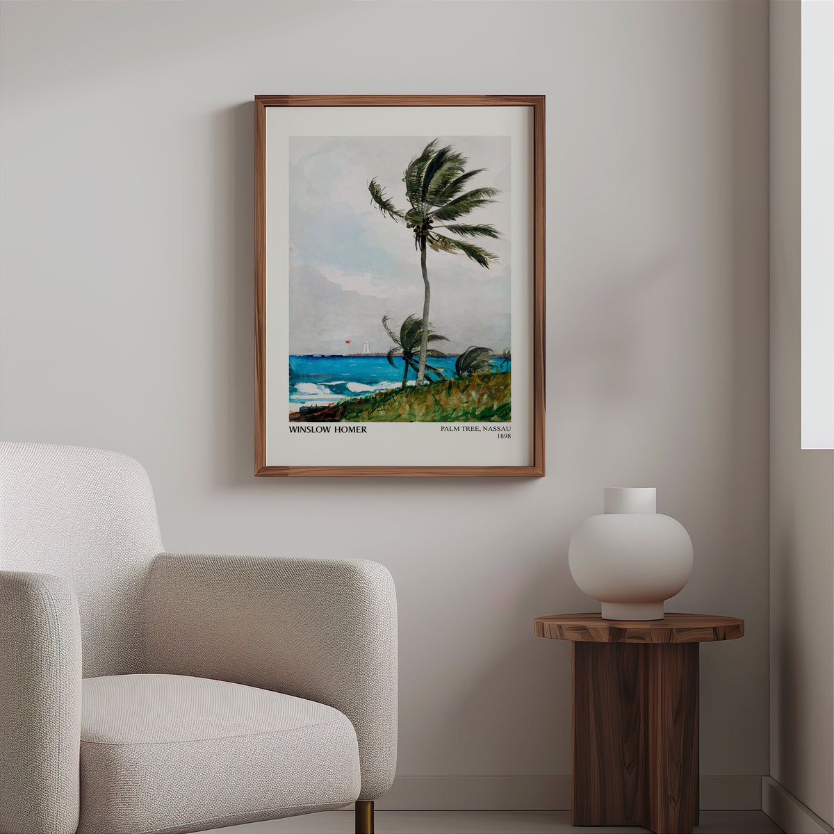 Homer palm watercolour in a slim walnut frame above a bouclé armchair