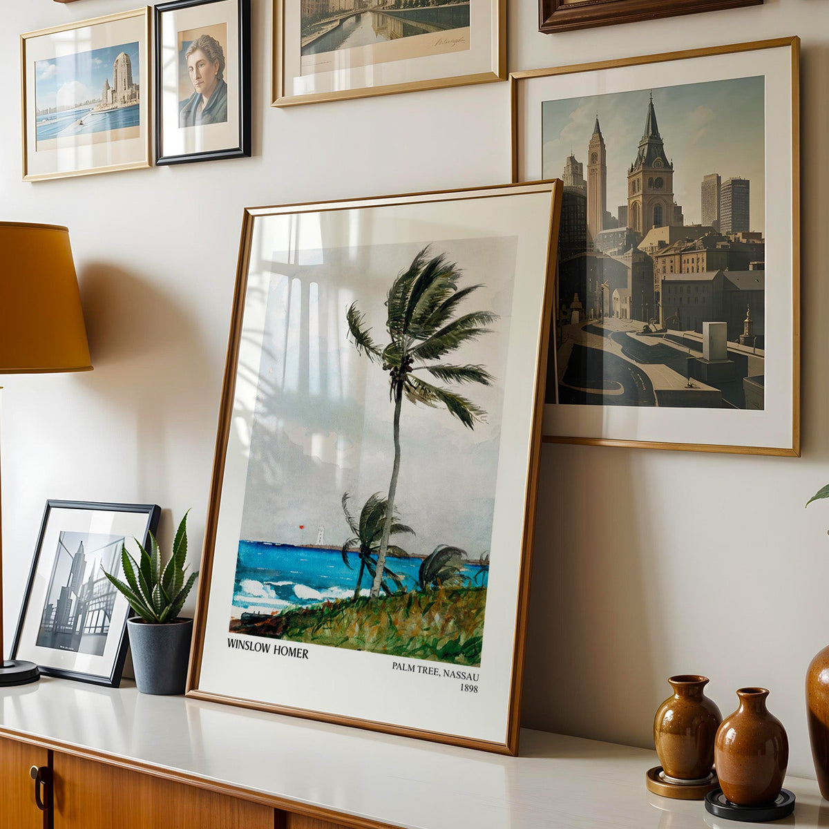 Homer watercolour shown in a gold frame leaning on a sideboard in a gallery wall