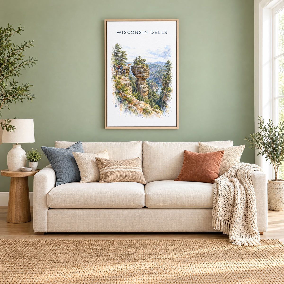 Wisconsin Dells watercolor print as a natural floater canvas above a cream linen sofa on a sage green wall