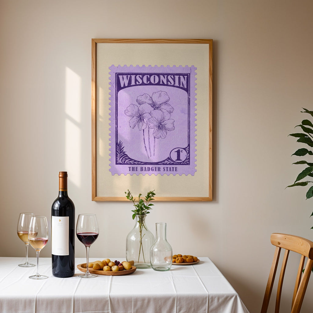 Wisconsin stamp print framed on the wall above a dining table set with wine, glasses and olives