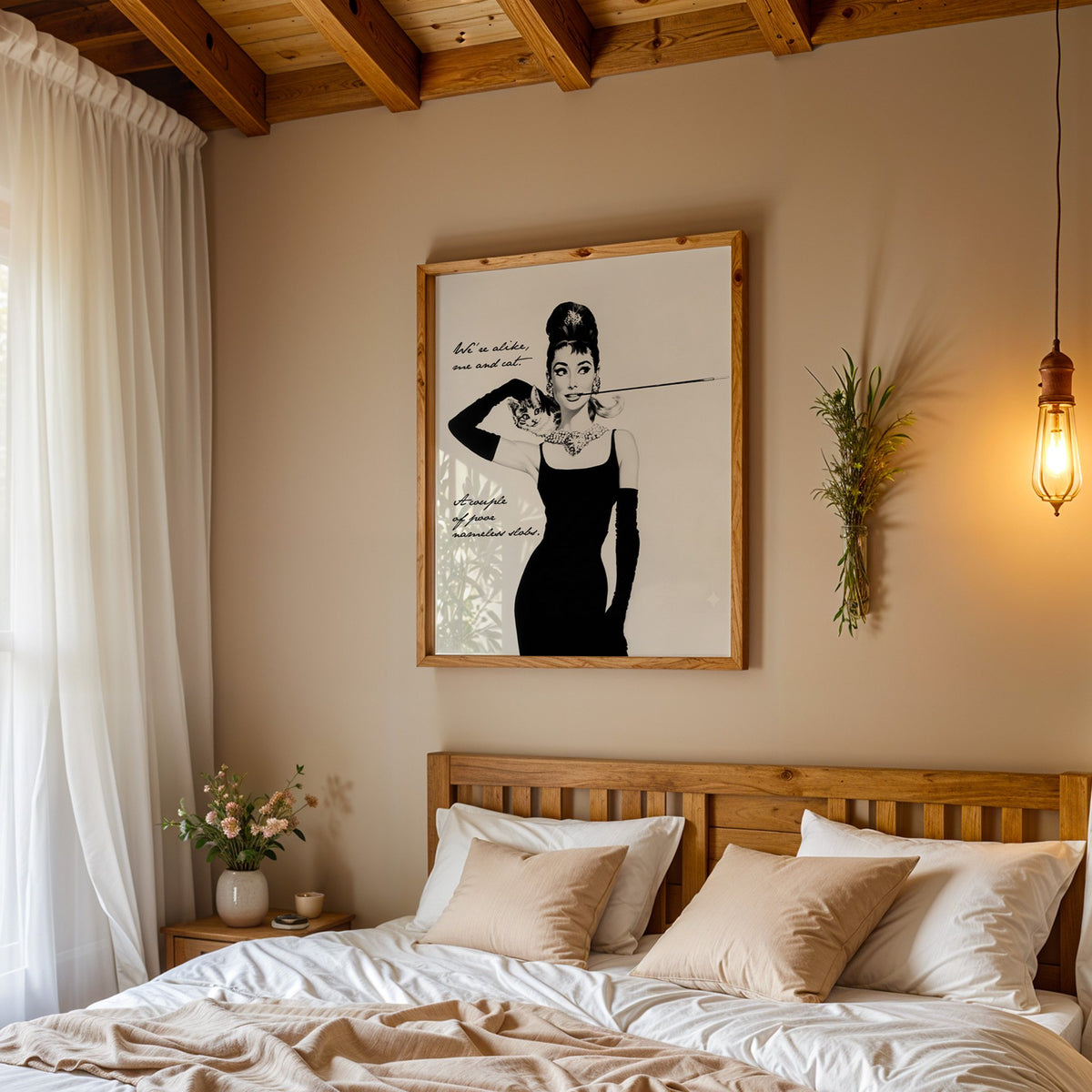Woman in black dress with kitten and handwritten quote print in a pine frame above a wood headboard bed under a pendant bulb