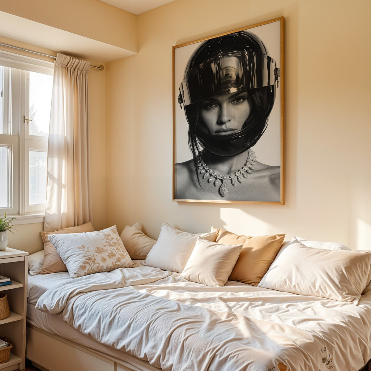 Woman in glossy black helmet and diamond necklace print in an oak frame above a cream daybed in a sunny bedroom