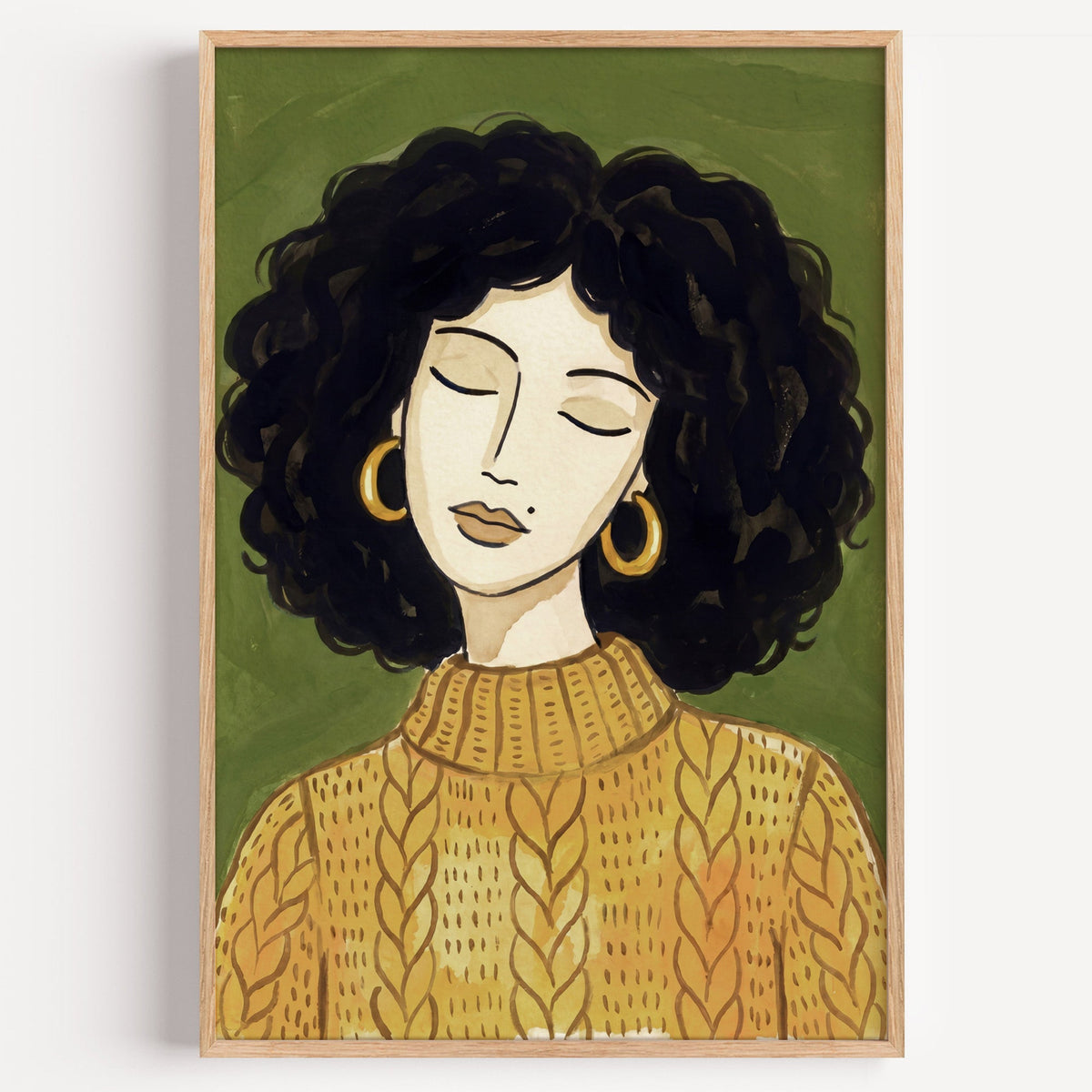 Woman with curly hair portrait print in a light oak frame on a plain white wall