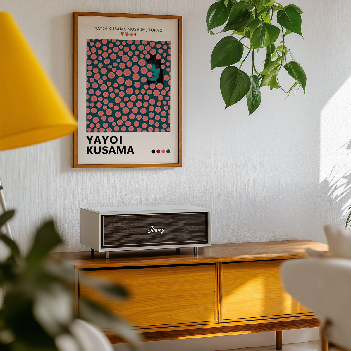 Yayoi Kusama inspired pink dots portrait print above a sideboard with a plant