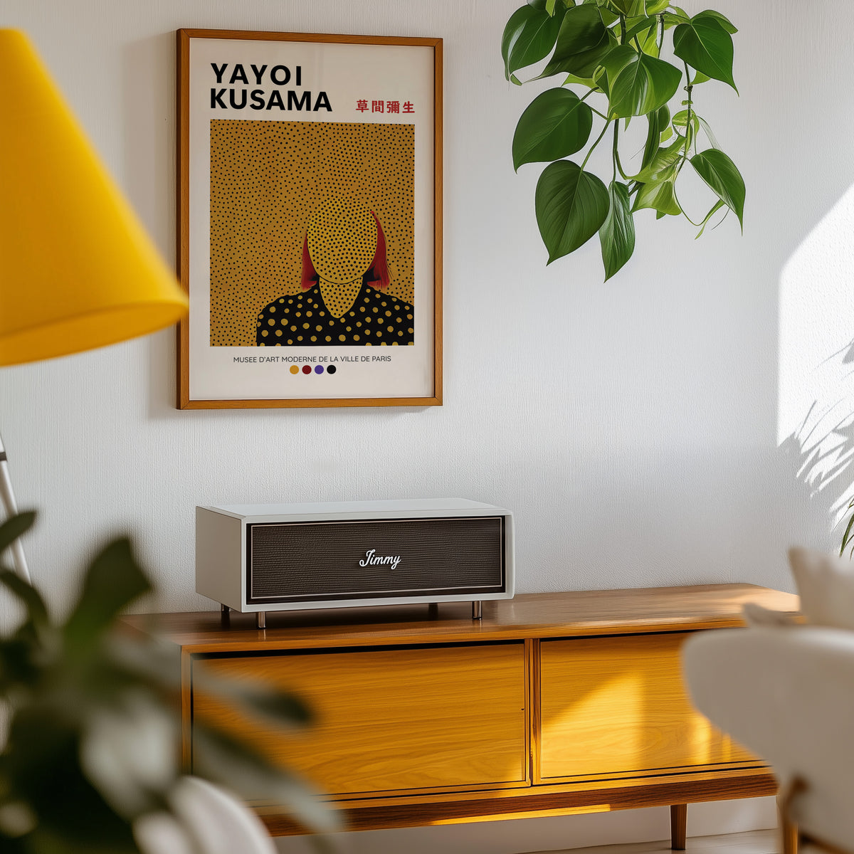 Yayoi Kusama inspired gold dots portrait print above a sideboard with a plant