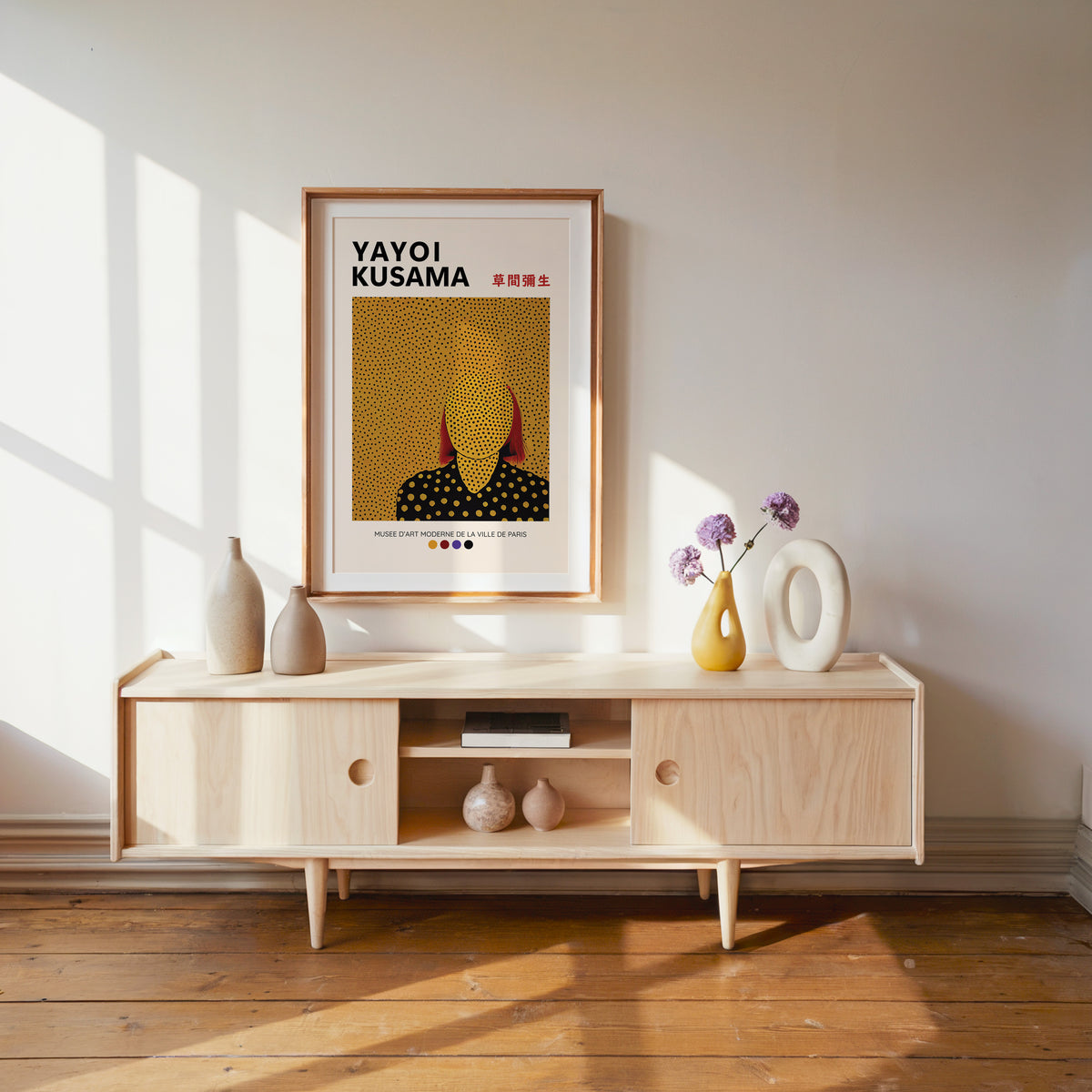 Yayoi Kusama inspired gold dots portrait print above a pale wood console