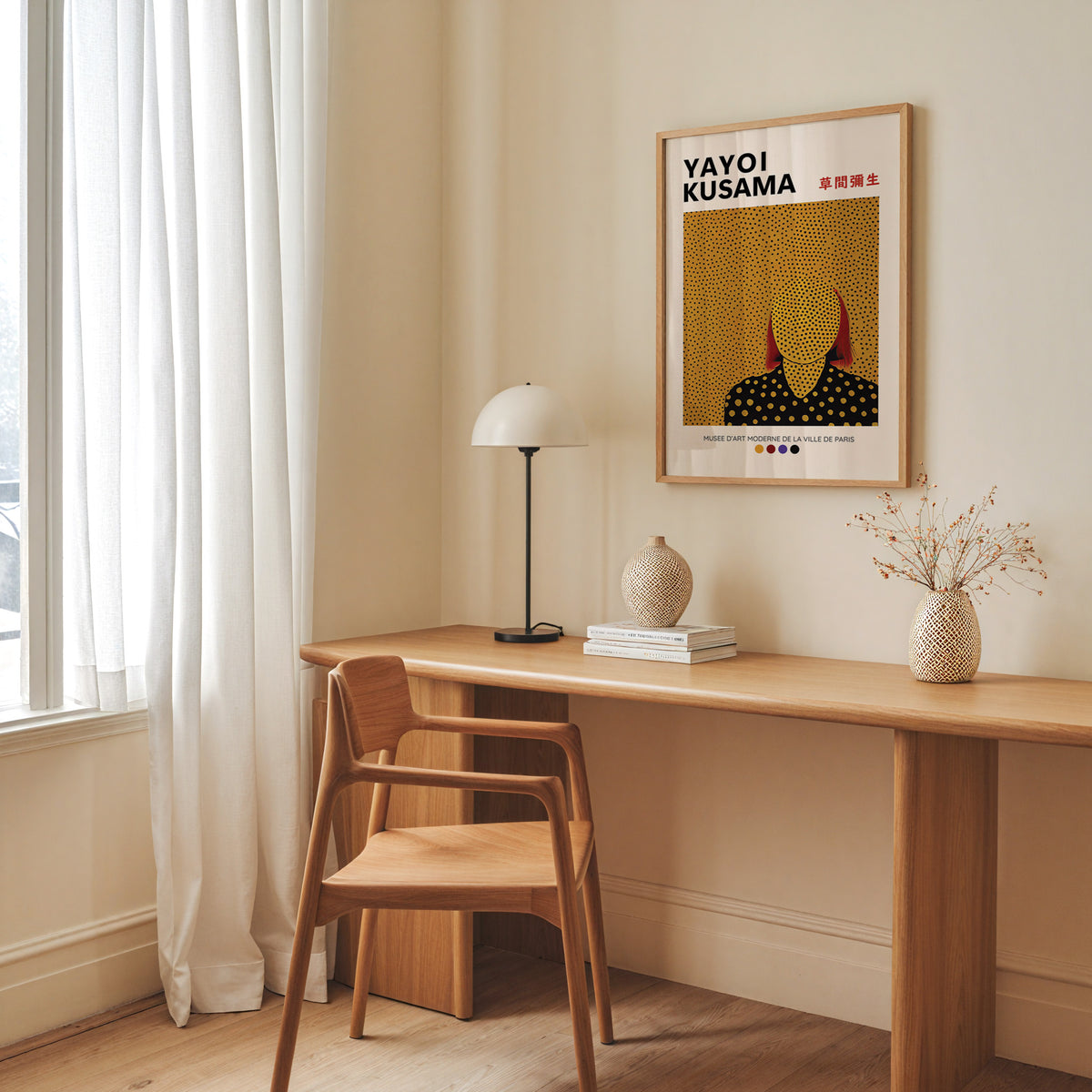 Yayoi Kusama inspired gold dots portrait print above a desk with a dome lamp