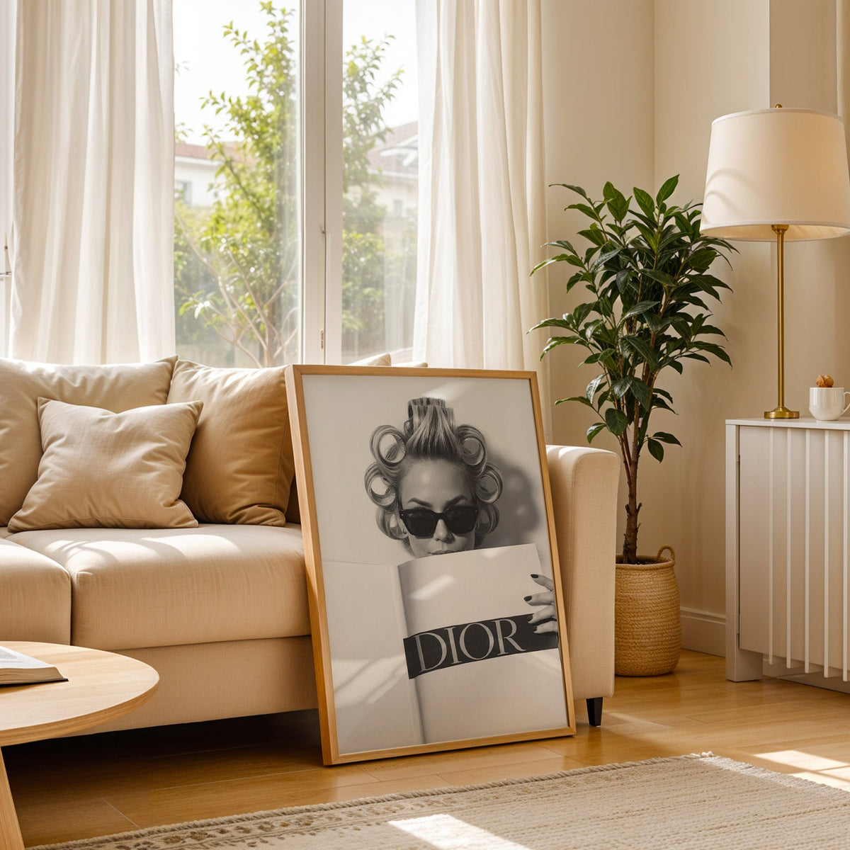 Woman in hair rollers and sunglasses behind magazine print in a light oak frame leaning on a cream sofa beside a floor lamp