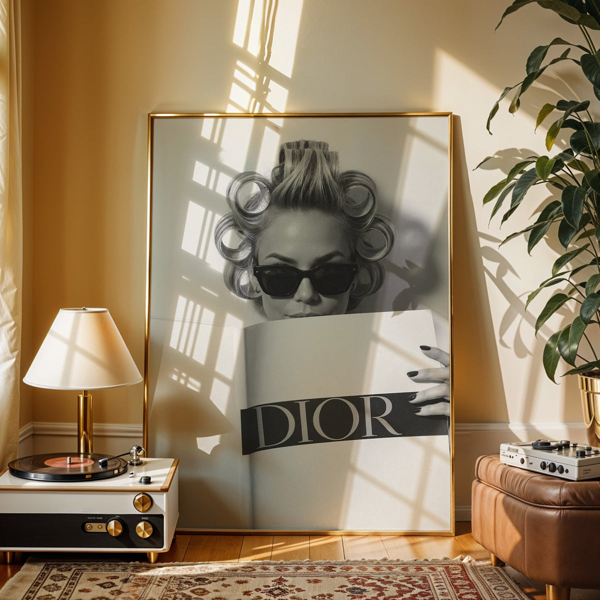 Woman in hair rollers and sunglasses behind magazine print shown in a gold frame beside a record player and table lamp