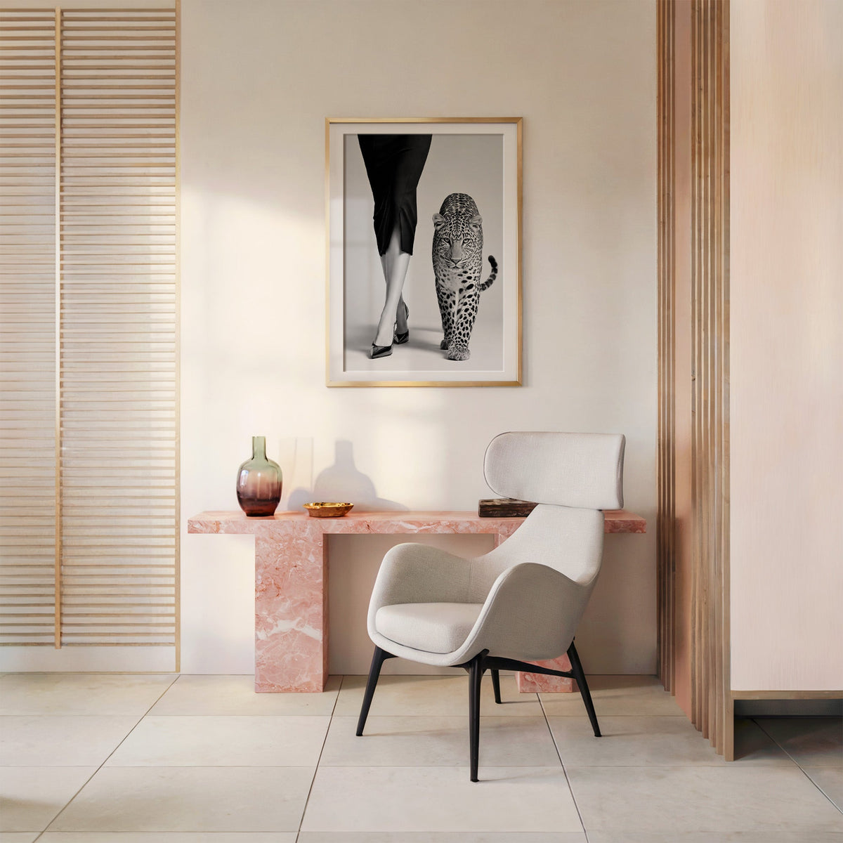 Woman's legs in heels walking beside leopard print shown in a gold frame above a pink marble console and armchair