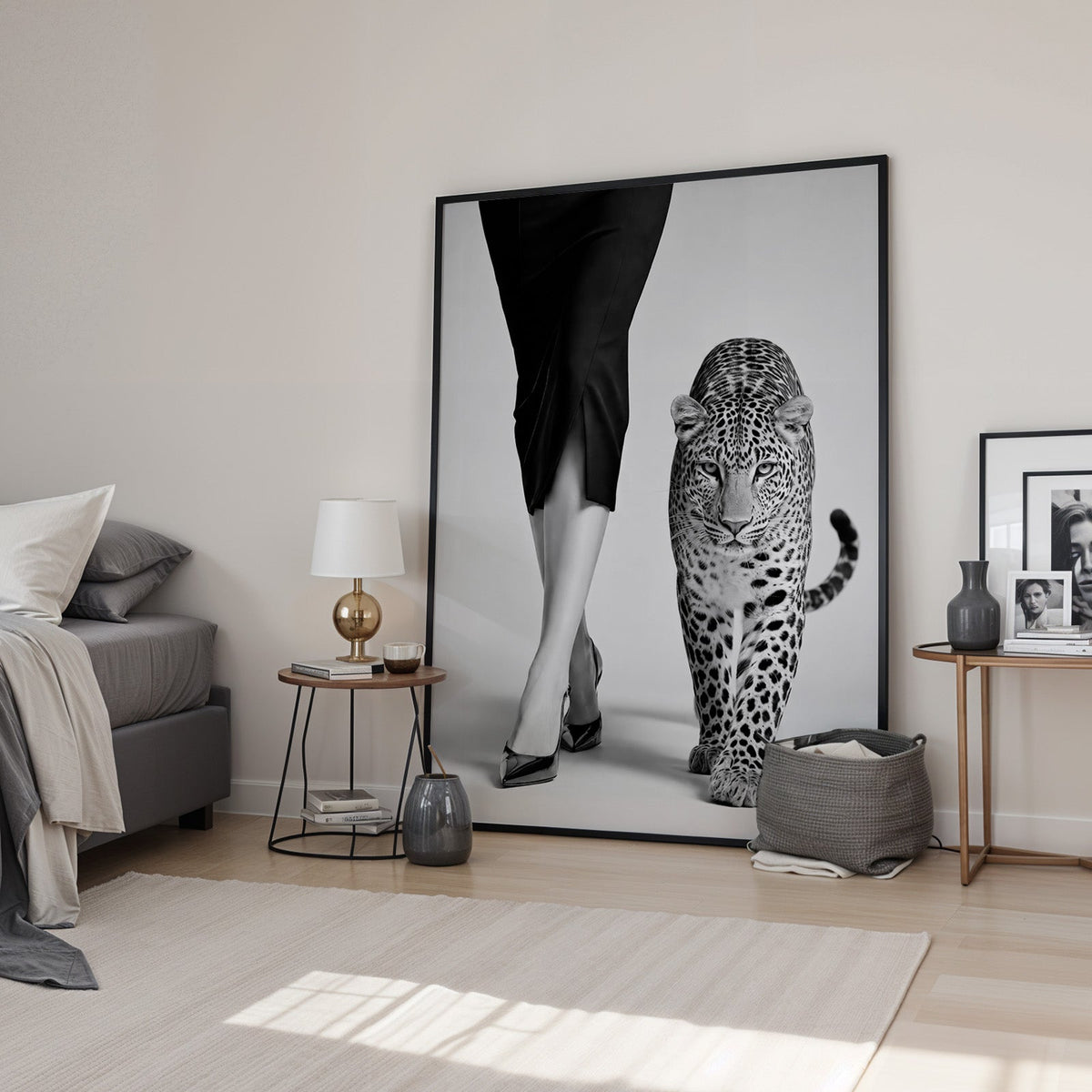 Woman's legs in heels walking beside leopard print in a black frame leaning in a bedroom beside a gold lamp