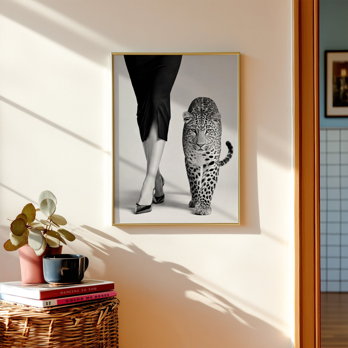 Woman's legs in heels walking beside leopard print shown in a gold frame above a wicker basket and stacked books