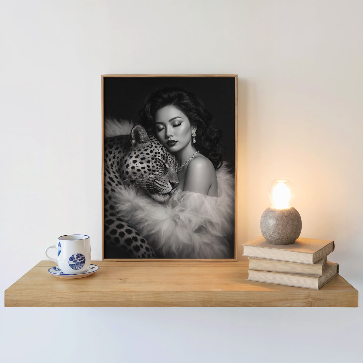 Woman leaning on leopard in fur black and white print in an oak frame on a floating shelf beside a glowing lamp
