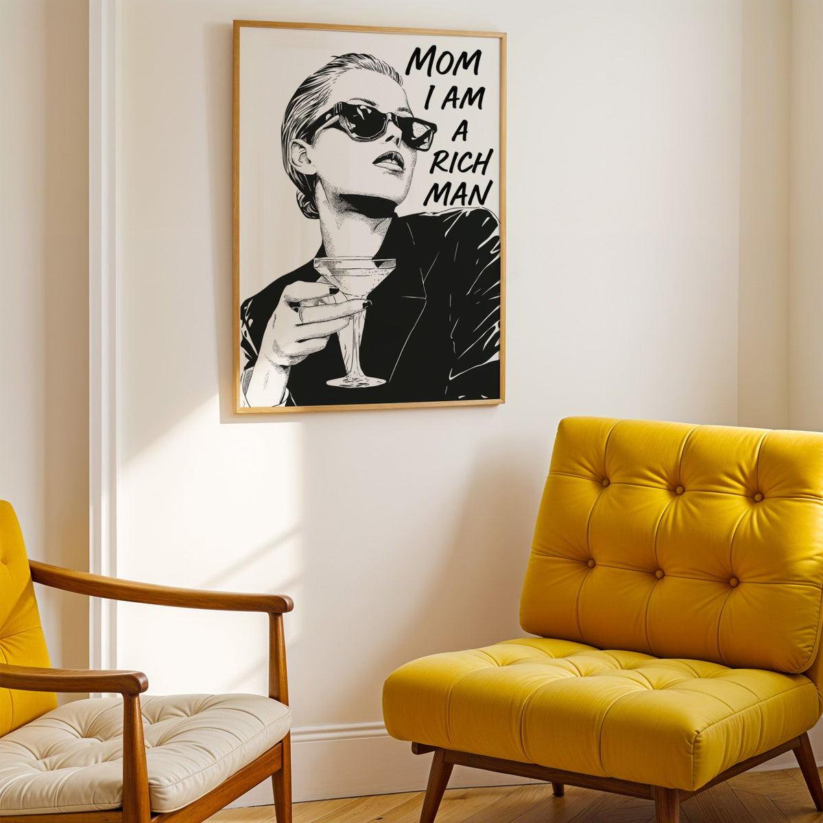 Woman in sunglasses with martini ink print shown in a gold frame above a mustard yellow tufted armchair