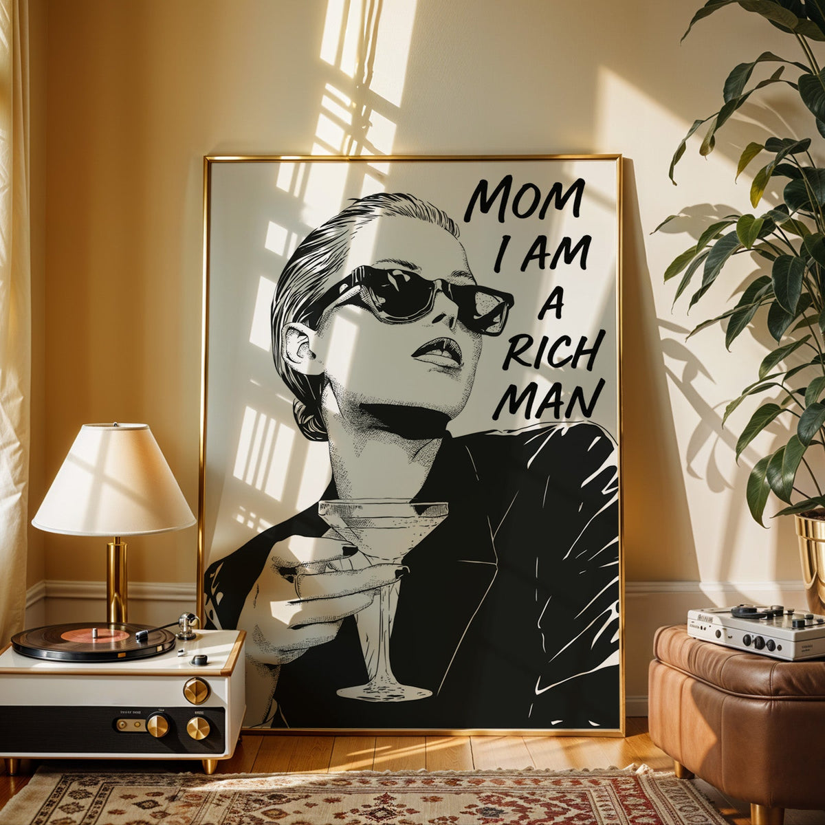 Woman in sunglasses with martini ink print shown in a gold frame beside a record player and table lamp