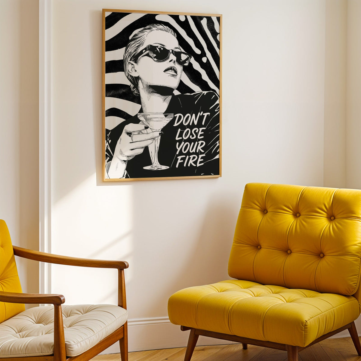 Woman with martini on zebra stripe backdrop ink print shown in a gold frame above a mustard yellow tufted armchair
