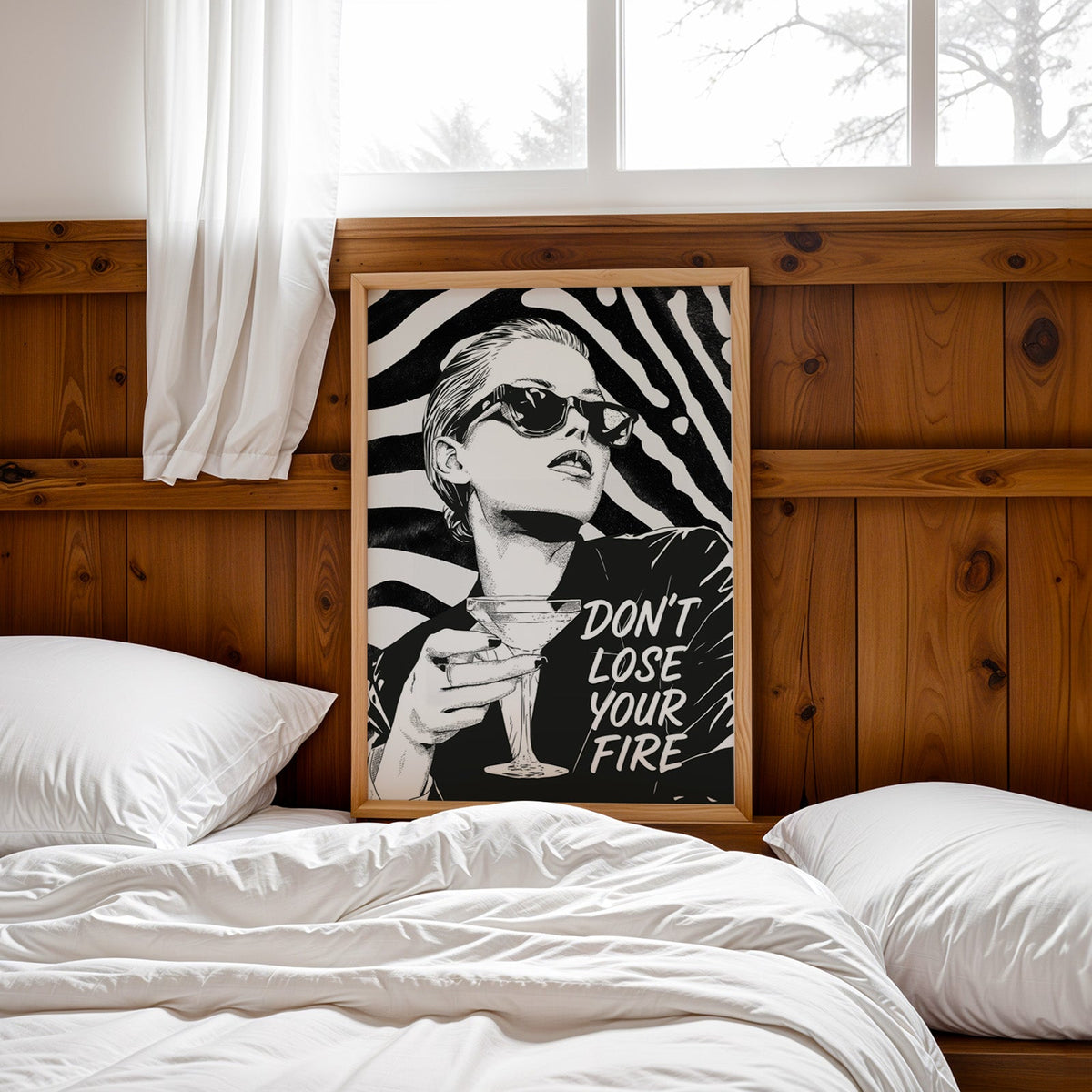 Woman with martini on zebra stripe backdrop ink print in a pine frame leaning on a wood headboard over white bedding