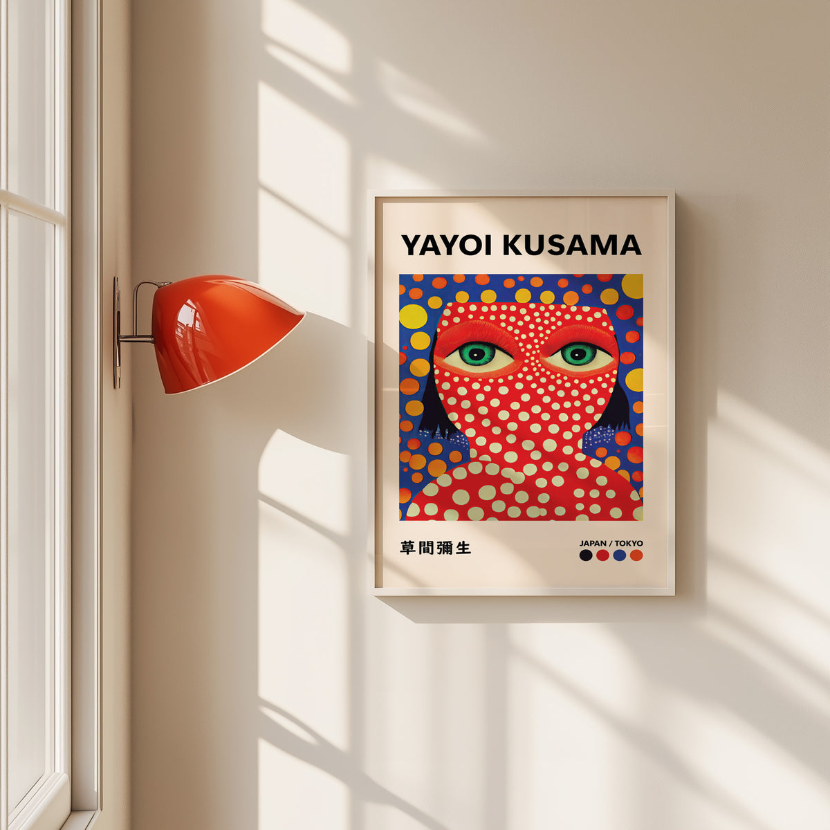 Yayoi Kusama inspired red face green eyes print in a white frame by a red wall lamp