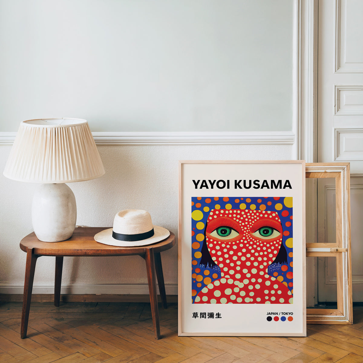Yayoi Kusama inspired red face green eyes print beside a bench and straw hat