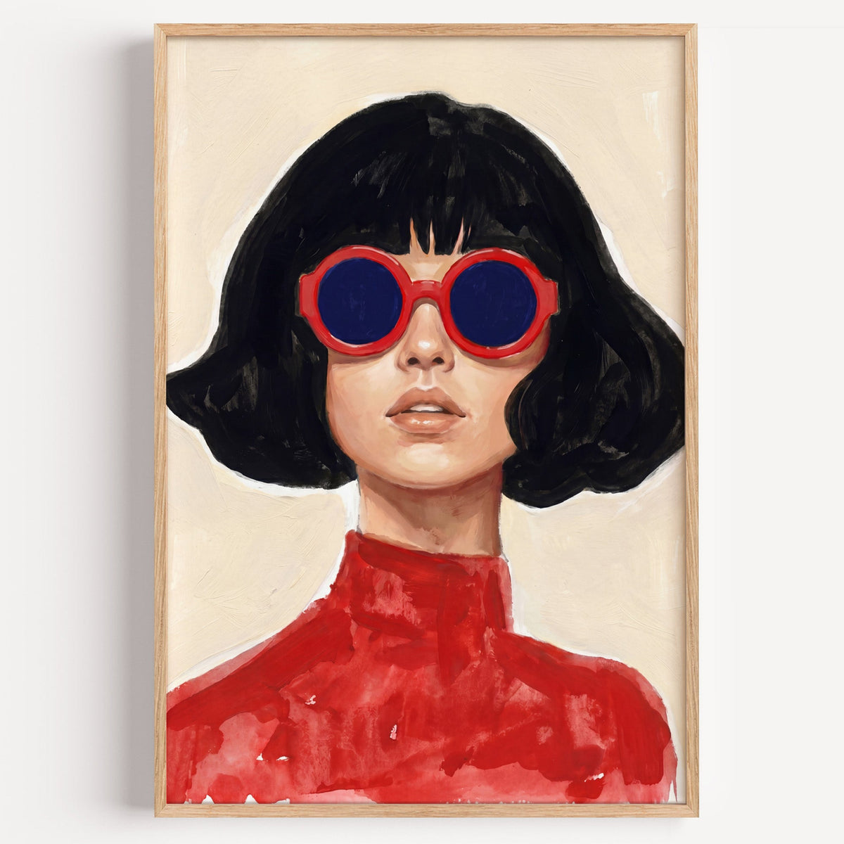 Woman in red round sunglasses print in a light oak frame on a plain white wall