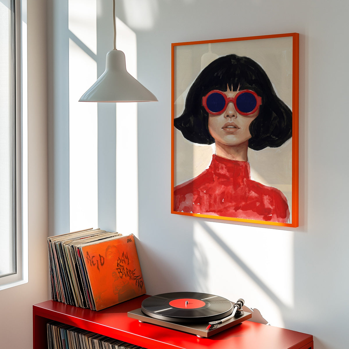 Black bob woman print shown in an orange frame above a red record cabinet and turntable
