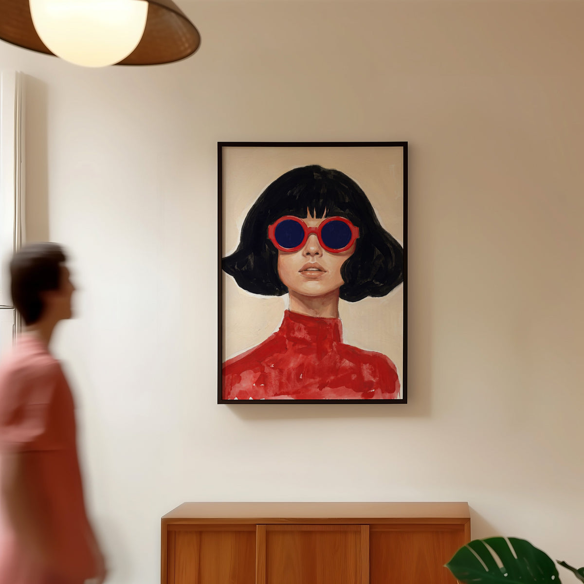 Mod sunglasses portrait print in a black frame in a hallway under a rattan pendant