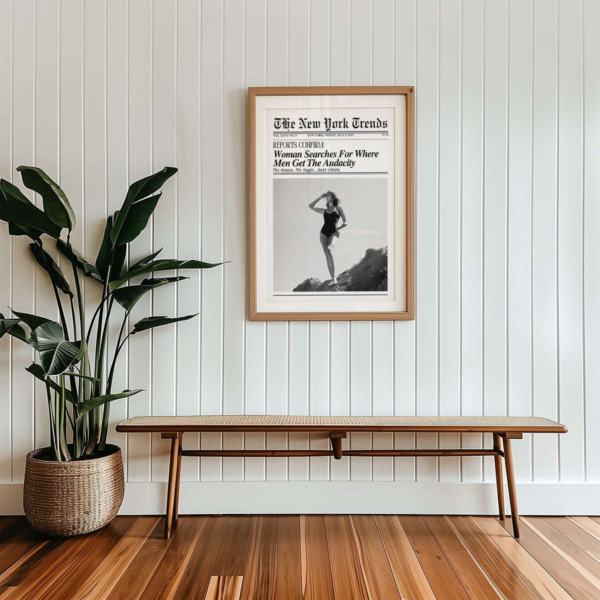 Woman on rocks shading her eyes mock newspaper print in a wood frame with a white mat above a cane bench