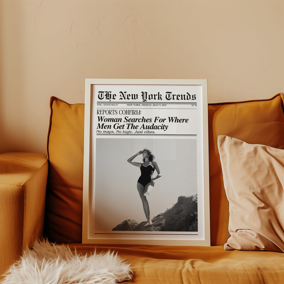 Woman on rocks shading her eyes mock newspaper print in a white frame leaning on a mustard velvet sofa