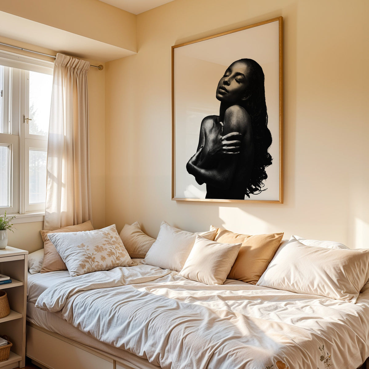 Backlit woman silhouette hugging her shoulders print in an oak frame above a cream daybed in a sunny bedroom